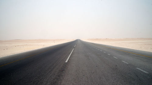 Empty road against clear sky