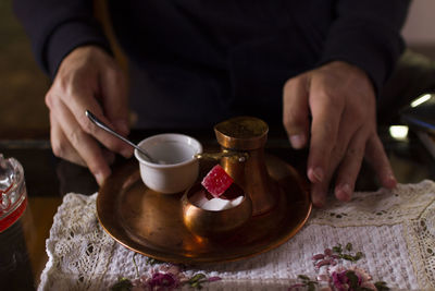 Midsection of man holding a cup of coffee