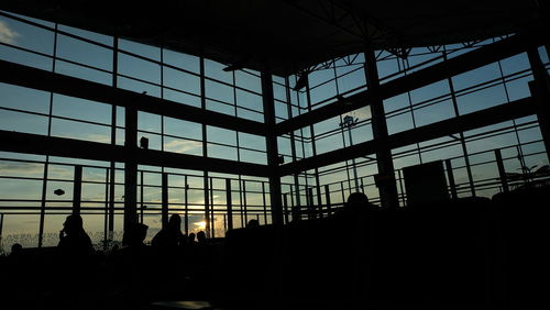 Low angle view of sky seen through glass building during sunset