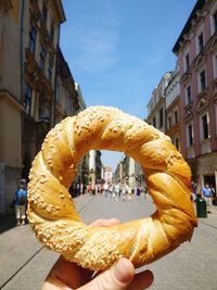 Person holding ice cream cone on street