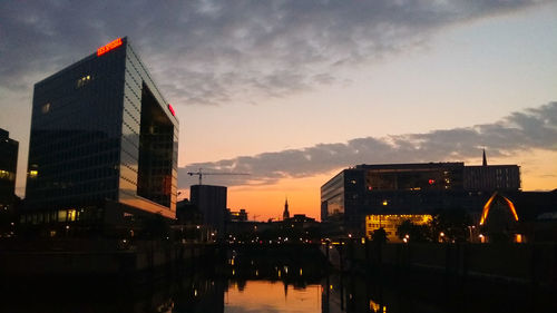 View of city lit up at sunset