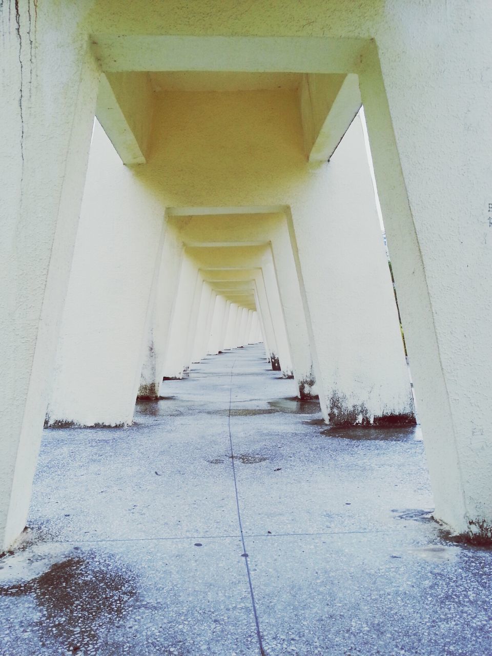 architecture, built structure, the way forward, building exterior, diminishing perspective, building, in a row, architectural column, corridor, day, indoors, no people, narrow, vanishing point, empty, walkway, railing, column, sunlight, long
