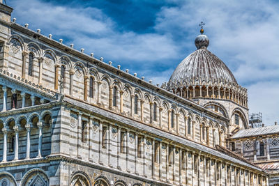 Low angle view of historical building against cloudy sky