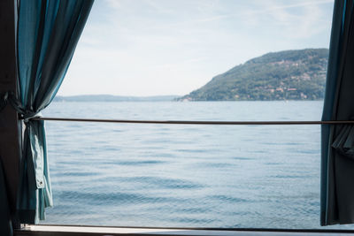 Scenic view of sea against sky seen through window