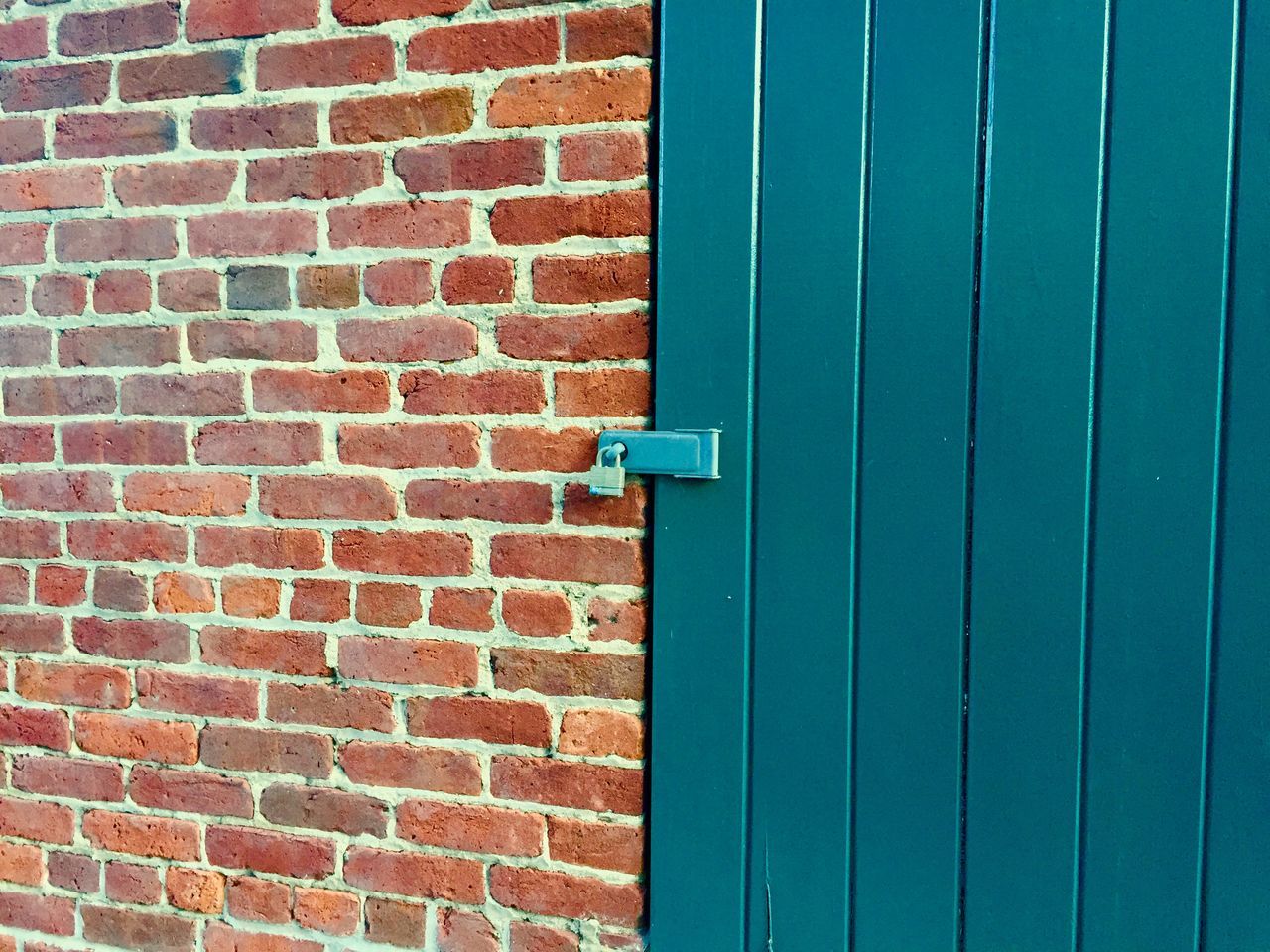 wall - building feature, built structure, architecture, building exterior, brick wall, wall, red, blue, protection, door, safety, closed, day, outdoors, no people, security, textured, pattern, low angle view, close-up