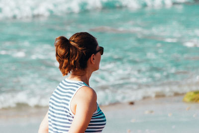 Rear view of woman standing on beach