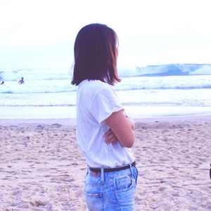 Rear view of girl standing on beach