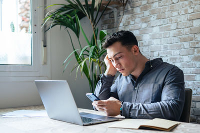 Young woman using laptop at office
