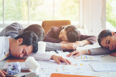 Colleagues sleeping at conference table