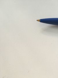 Close-up of pencils on table against white background