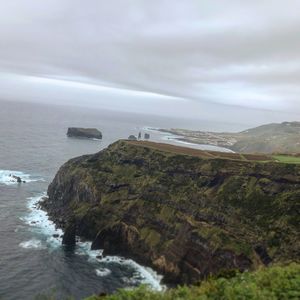 Scenic view of sea and mountains against sky