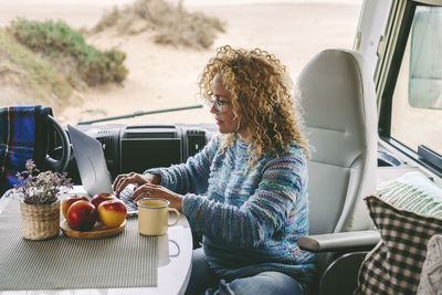 Portrait of woman sitting in car