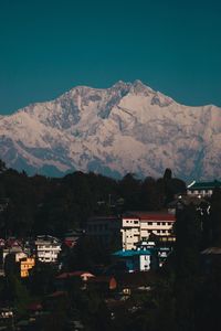 High angle view of townscape and mountains against sky
