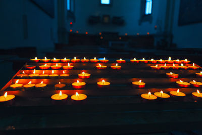 Candles in catholic church . candlelight in the dark room