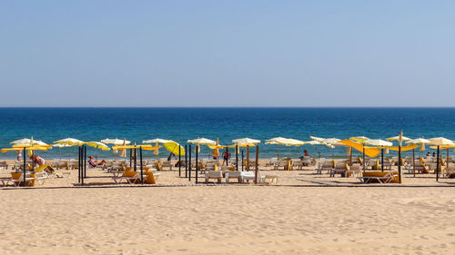 Scenic view of beach against clear sky