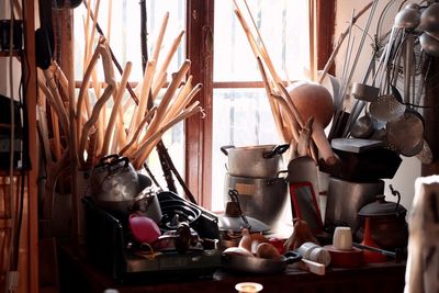 Utensils by window in kitchen at home