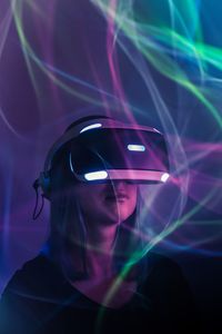 Woman using virtual reality simulator by light paintings