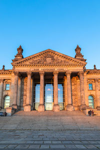 Low angle view of historical building against blue sky