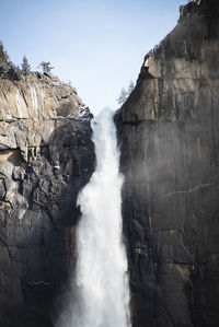 Scenic view of waterfall against sky