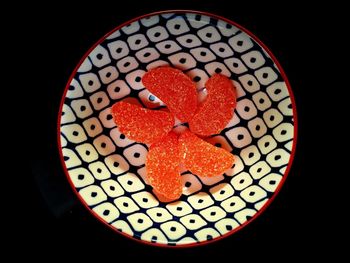 High angle view of heart shape on table against black background