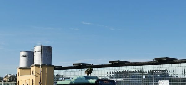 Low angle view of factory against blue sky