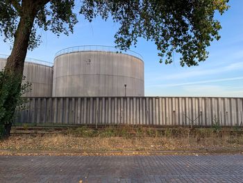 View of gasoline storage against sky