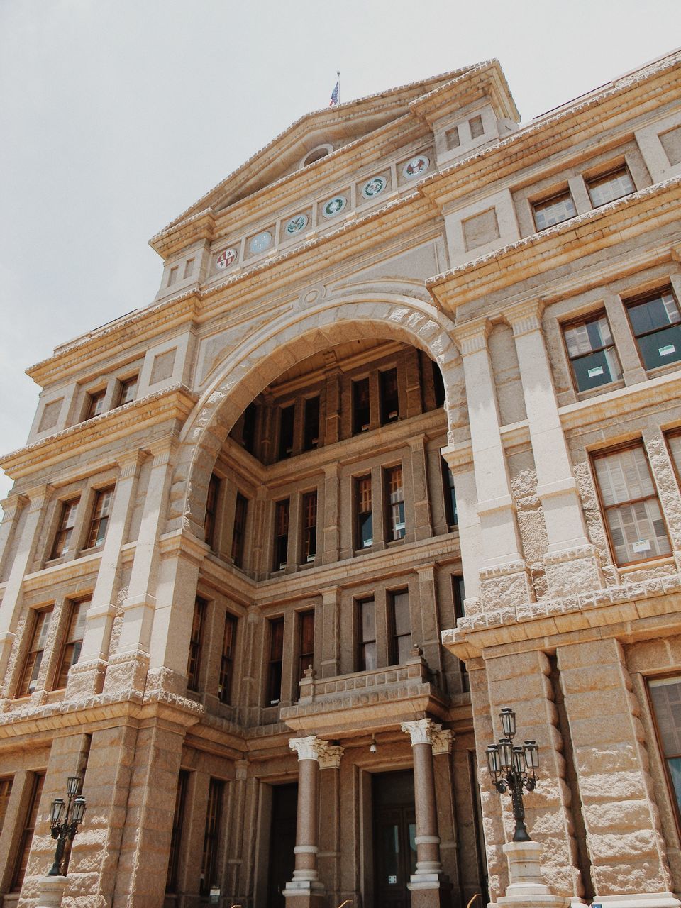 architecture, built structure, building exterior, low angle view, history, travel destinations, famous place, facade, tourism, architectural column, old, city, capital cities, arch, sky, day, outdoors, building, historic, ornate, no people, the past, architectural feature, culture