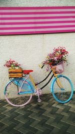 Multi colored bicycle against red wall