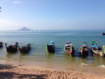 Boats moored on sea against sky