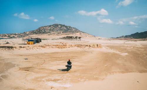 Full length of man on sand at beach against sky