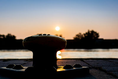 Close-up of silhouette pier against sky during sunset