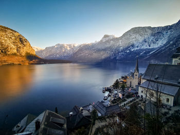 Lake and buildings against sky