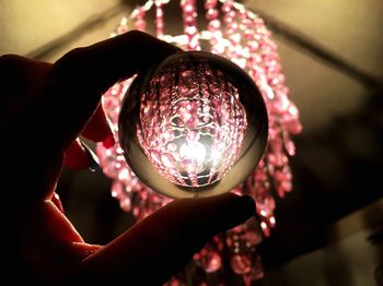 Close-up of hand holding crystal ball