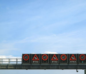 Information sign on bridge against sky