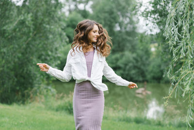 Happy girl with long wavy hair blowing in the wind in nature