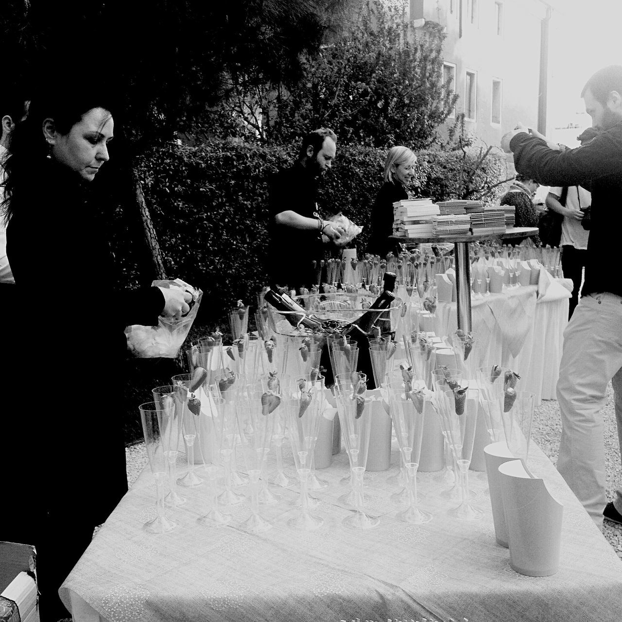 lifestyles, water, leisure activity, men, standing, casual clothing, person, reflection, boys, full length, togetherness, holding, outdoors, wet, childhood, motion, fountain