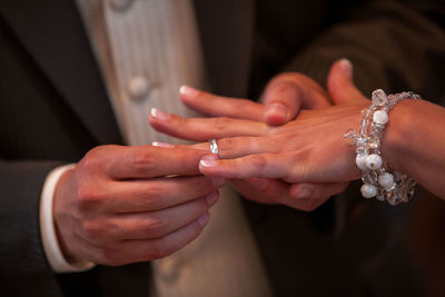 Midsection of couple having engagement ceremony