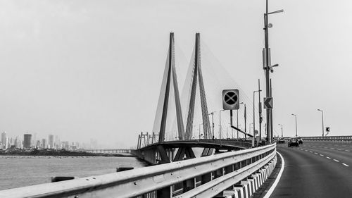 Bridge over road against sky in city