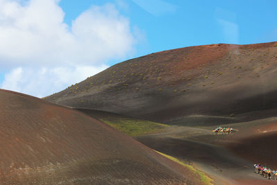 Scenic view of road by land against sky