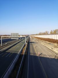 Highway against clear blue sky