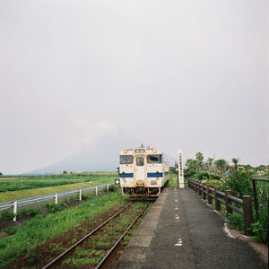 Train on railroad track against sky