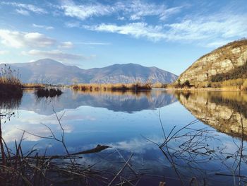 Scenic view of lake and mountains against sky