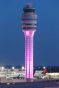 Illuminated tower against blue sky at night