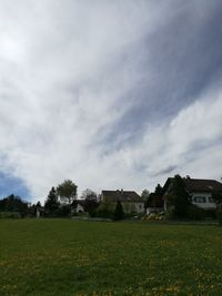 Houses on field against sky