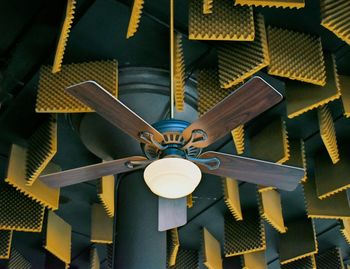 Low angle view of electric lamp hanging on ceiling