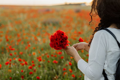 Rear view of woman holding flower