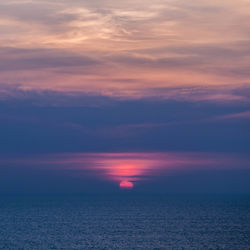 Scenic view of sea against romantic sky at sunset