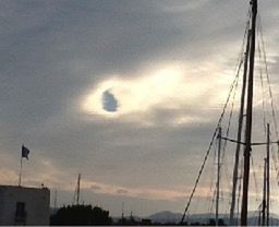 Low angle view of power lines against cloudy sky