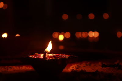 Close-up of lit candles in the dark