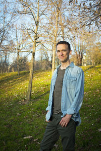 Portrait of young man standing on field